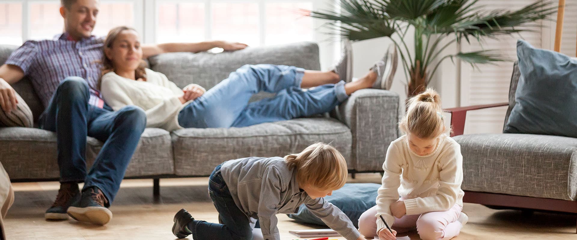 Family relaxing at home in their living room